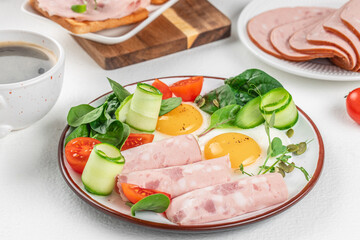 Wall Mural - Plate of breakfast with fried eggs, ham and salad. Keto breakfast. Brunch