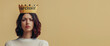 © salarko - Narcissist word on a paper crown of an young arrogant woman on beige background, concept of narcissism, Narcissistic personality disorder in adults. Banner with copy space for text