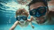 © Wilasinee - Close up of a father and child diving underwater together both wearing protective goggles and enjoying a fun playful moment in the water