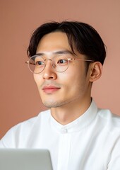 Fototapete - Minimalist Digital Focus Young Asian Professional with Modern Eyewear in a Tech-Driven Workspace - Enhancing Ergonomics and Visual Clarity for Digital Marketing Success