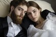 © Alena - A man and a woman relaxing together on a couch, with a calm atmosphere