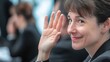 © Alla - A professional woman in a business suit gestures with her hand, likely conveying enthusiasm or agreement