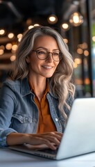 Poster - Confident and Stylish Mature Woman Working Remotely at Cafe, Enjoying Work-Life Balance
