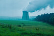 © Sahir_Designs - Industrial cooling tower emitting steam in green countryside, power generation environmental impact