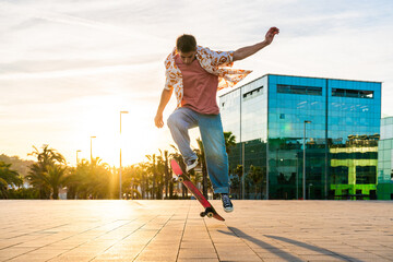 Wall Mural - Handsome young man portrait outdoors - Modern cool male wearing stylish urban clothing strolling in the city with skateboard