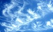 © Resni AI - Wispy white clouds streak across a vibrant blue sky, ideal for nature backgrounds