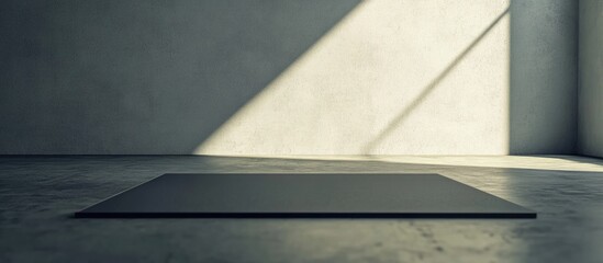 Poster - Minimalist interior space with gray concrete wall and floor, featuring a dark rectangular platform and diagonal light shadows, Copy Space