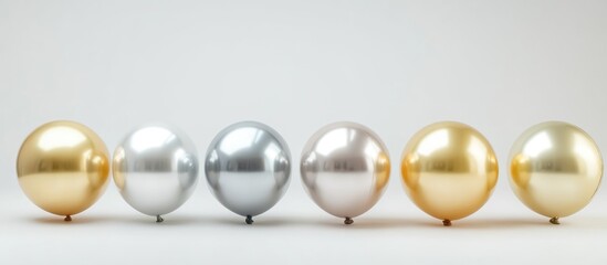 Poster - Elegant arrangement of golden and silver reflective spheres on a light background with copy space for text.