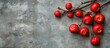 © AbstractAI - Vibrant red apples on branches set against a textured gray background in a natural garden environment featuring ample empty space for text.