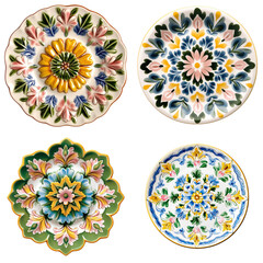 Poster - Four plates showcasing various intricate designs and patterns arranged on a wooden table on white background , cut out.