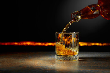 Wall Mural - Whiskey is poured into a crystal glass.