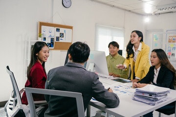 Fototapete - Five business professionals collaborating on a project, analyzing data and discussing strategies during a productive office meeting, fostering teamwork and innovative solutions