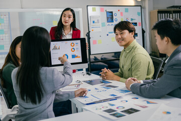 Poster - Business colleagues are collaborating on a project, analyzing charts and graphs displayed on a computer screen during a productive office meeting