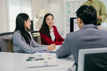 Aufkleber - Business professionals engaging in a productive meeting, analyzing financial charts and graphs on screens and documents to foster collaboration and strategic decision-making