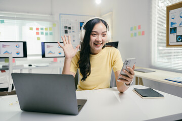 Aufkleber - Young businesswoman happily waves during a video call in her home office, showcasing modern technology for remote work
