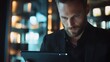 © arinda_BJ - Man using tablet, dimly lit lounge, blurred background, business