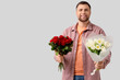 © Pixel-Shot - Delivery man with flowers on light background