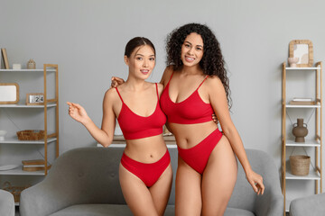 Canvas Print - Beautiful young women in sexy red underwear hugging at home