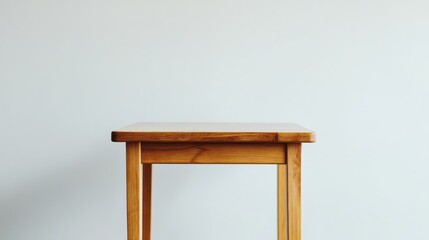 Canvas Print - Simple Wooden Table Against a Light Wall: A Minimalist Interior Design