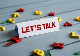 Poster - Sign that says Let's Talk on a table with colorful letters for communication and conversation