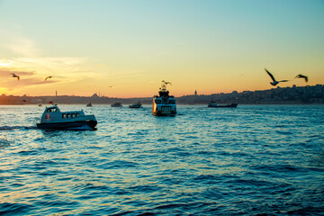 Wall Mural - moving boats and ships at sunset  in the bosphorus in istanbul, constantinople