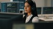 © Postmodern Studio - Woman wearing a headset is sitting in front of a computer monitor