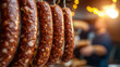 © kaliel - Factory for the production of meat products, cured sausages. Traditional spicy sausage hanging to dry, covered with fungus. Concept of handmade meat products. Delicacy