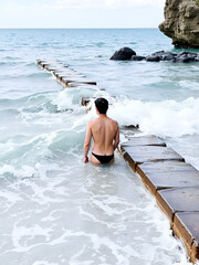 The breakwater of the sea is a lonely bather