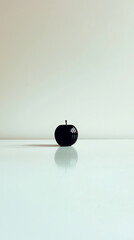 Poster - Reflective Red Apple on a Pristine White Desk, Showcasing Minimalism and Beauty in Simplicity