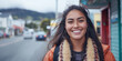 © VALUEINVESTOR - Portrait of a smiling beautiful Māori woman in a New Zealand town, generative AI