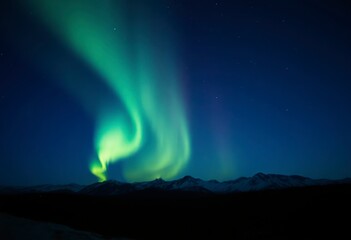 vibrant northern lights grace the night sky above majestic mountains, creating a magical atmosphere 