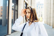 © Raisa Kanareva - Fashionable woman in the city. Young female model with long hair wears white shirt.