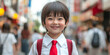 © VALUEINVESTOR - A cute little girl with short hair, wearing a white school uniform and red tie, smiling at the camera in front of a bustling street background, generative AI