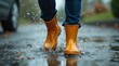 © Alex Pios - Close-up of rain boots splashing in a puddle, water droplets captured mid-air