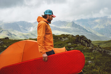 Wall Mural - man climbing mountains with camping gear tent and sleeping pad - travel solo adventure healthy lifes