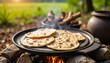 © Ferdinand - Chapati cooking on tawa in rural outdoor setup, culinary tradition