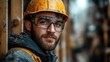 © aritha - Young construction worker in safety gear looks confidently at the camera amidst a busy construction site