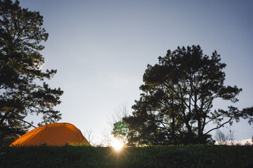 landscape and travel concept with sunset with camping tent on mountain