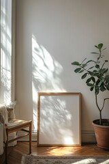 Poster - Sunlight casts shadows on a blank frame and potted plant in a minimalist living room, creating a serene and cozy atmosphere.