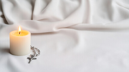 Wall Mural - Lit candle and rosary on white fabric representing assumption of mary