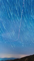 Wall Mural - night sky stars with trails, vertical time lapse view