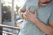 © New Africa - Man having heart attack outdoors, closeup view