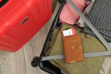 Wall Mural - Passport with ticket on packed suitcase indoors, top view