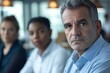 © JAYDESIGNZ - Mature serious business man, team leader coaching, mentor talks to diverse business people in office to show, explain strategy at corporate group meeting, multiethnic staff listen to boss at briefing