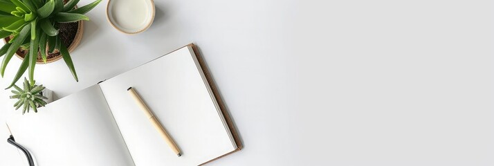 Wall Mural - A shot of a desk with an open notebook, pen and plant pots on a white background. Web banner with copy space on the right