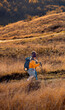 © Zoran Zeremski - Two smiling woman hiking at top of the hill at meadow.
