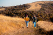 © Zoran Zeremski - Two smiling woman hiking at top of the hill at meadow.