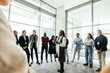 © Jacob Lund - Leader addressing a crowd at a seminar in a modern office space