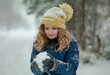 © Volodymyr - Winter kids portrait in snow. Kid winter face in snow. Happy Winter Children Holidays. Emotional Smiling Child Having Fun Playing with Snowflakes in Snow Park. Snow Falling in Winter Vacations.