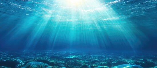 Poster - Underwater scene with sunlight rays penetrating through water surface creating a tranquil blue atmosphere Copy Space